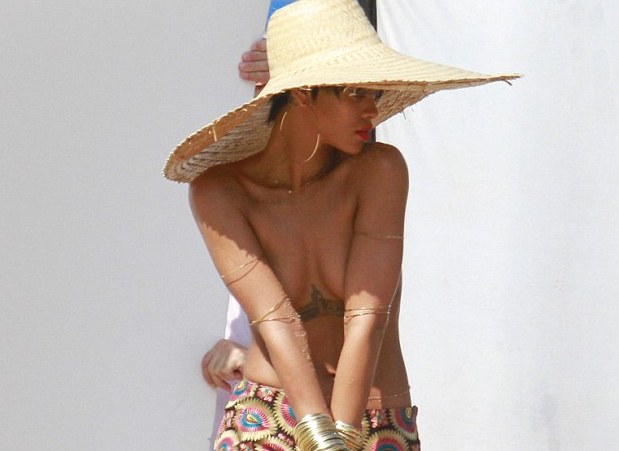 Rihanna poses topless for Vogue 